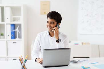 Image showing businessman calling on smartphone at office