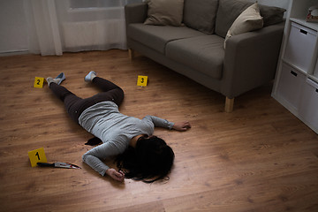 Image showing dead woman body lying on floor at crime scene