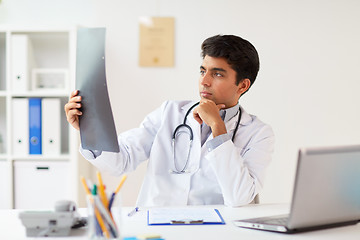 Image showing doctor looking at spine x-ray scan at clinic