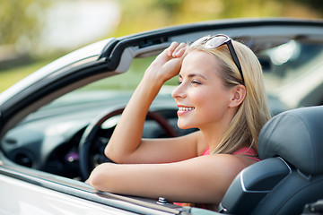 Image showing happy young woman in convertible car