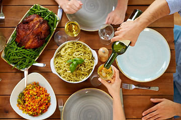 Image showing group of people eating and drinking wine