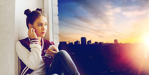 Image showing teenage girl with smartphone and earphones