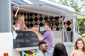 Image showing saleswoman at food truck serving male customer