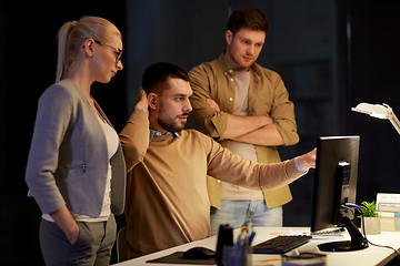 Image showing business team with computer working late at office