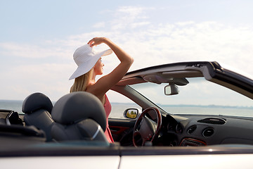 Image showing happy young woman in convertible car