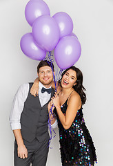 Image showing happy couple with ultra violet balloons at party