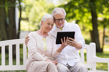 Image showing happy senior couple with tablet pc at summer park