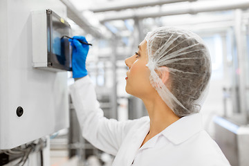 Image showing woman programming computer at ice cream factory