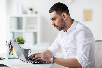 Image showing businessman typing on laptop at office