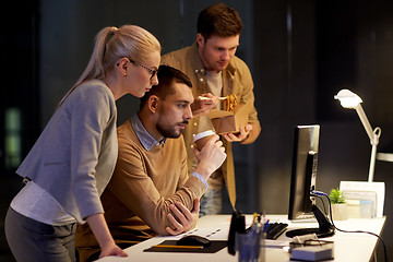 Image showing business team with computer working late at office