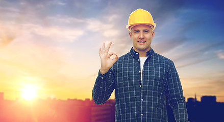 Image showing smiling builder in helmet showing ok hand sign