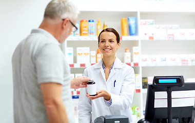 Image showing apothecary and senior customer at pharmacy