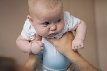 Image showing Father and baby son  playing on the bed.