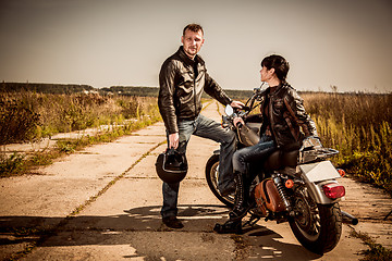 Image showing Bikers couple Man and woman near a motorcycle on the road