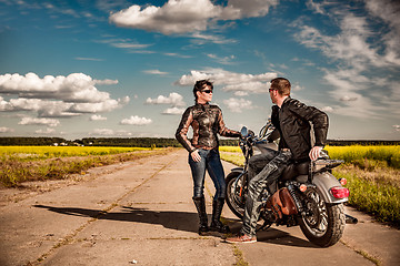 Image showing Bikers couple Man and woman near a motorcycle on the road