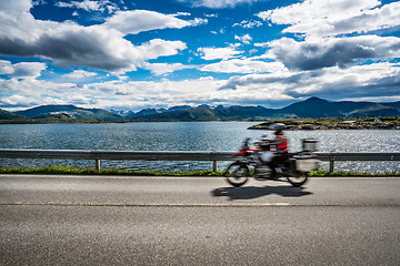 Image showing Biker rides a road with Atlantic Ocean Road in Norway.