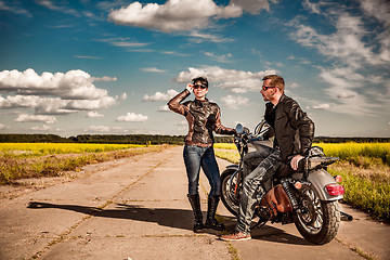 Image showing Bikers couple Man and woman near a motorcycle on the road