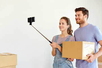 Image showing happy couple with boxes moving to new home