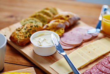 Image showing cream cheese and other food on table at breakfast