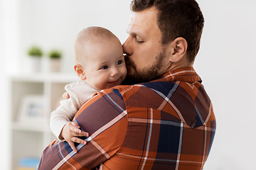 Image showing happy father kissing little baby boy at home