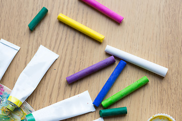 Image showing crayons and acrylic color or paint tubes on table