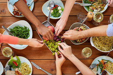 Image showing group of people eating at table with food