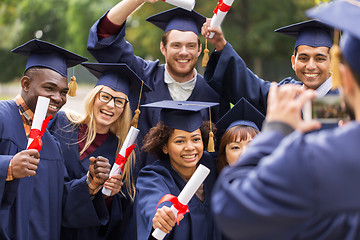 Image showing students or graduates with diplomas taking picture