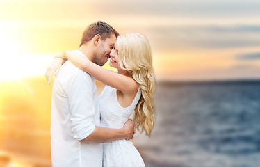 Image showing happy couple hugging and kissing on summer beach