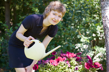Image showing woman watering flowers