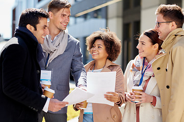 Image showing international business team with papers outdoors