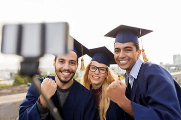 Image showing happy students or graduates taking selfie outdoors