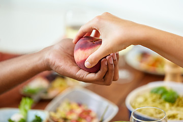 Image showing multiracial couple hands with peach