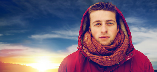 Image showing happy man in winter jacket with hood outdoors