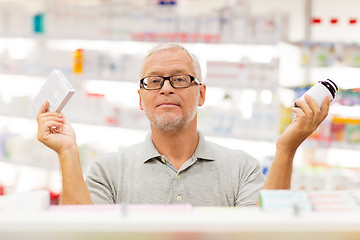 Image showing senior male customer choosing drugs at pharmacy