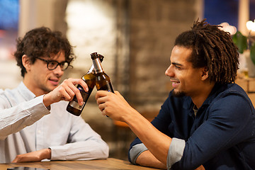 Image showing happy male friends drinking beer at bar or pub