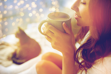 Image showing close up of happy woman with cup of cocoa at home