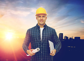 Image showing builder in hard hat with blueprint and clipboard