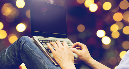 Image showing close up of man typing on laptop keyboard