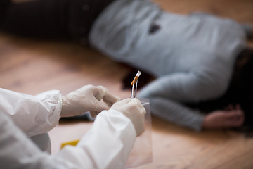 Image showing criminalist collecting crime scene evidence