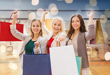 Image showing happy young women with shopping bags in mall