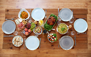 Image showing various food on served wooden table