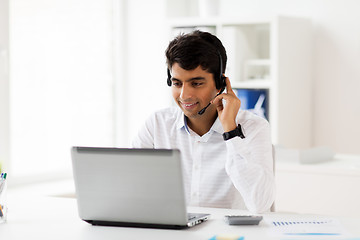 Image showing businessman with headset and laptop at office