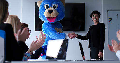 Image showing boss dresed as bear having fun with business people in trendy of