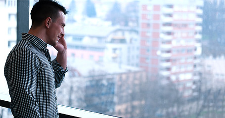 Image showing Business Man Talking On Cell Phone, Looking Out Office Window