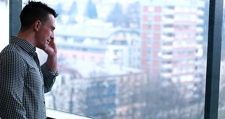 Image showing Business Man Talking On Cell Phone, Looking Out Office Window