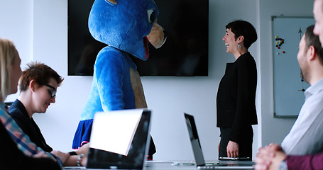 Image showing boss dresed as bear having fun with business people in trendy of