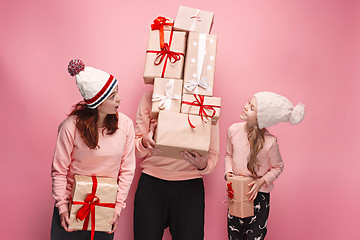 Image showing Father and mother give gifts to little daughter at studio