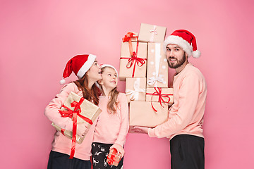 Image showing Father and mother give gifts to little daughter at studio