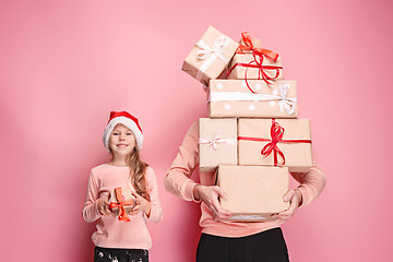 Image showing Portrait of a surprised little girl with her father holding a Christmas present