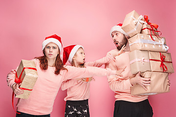 Image showing Father and mother give gifts to little daughter at studio